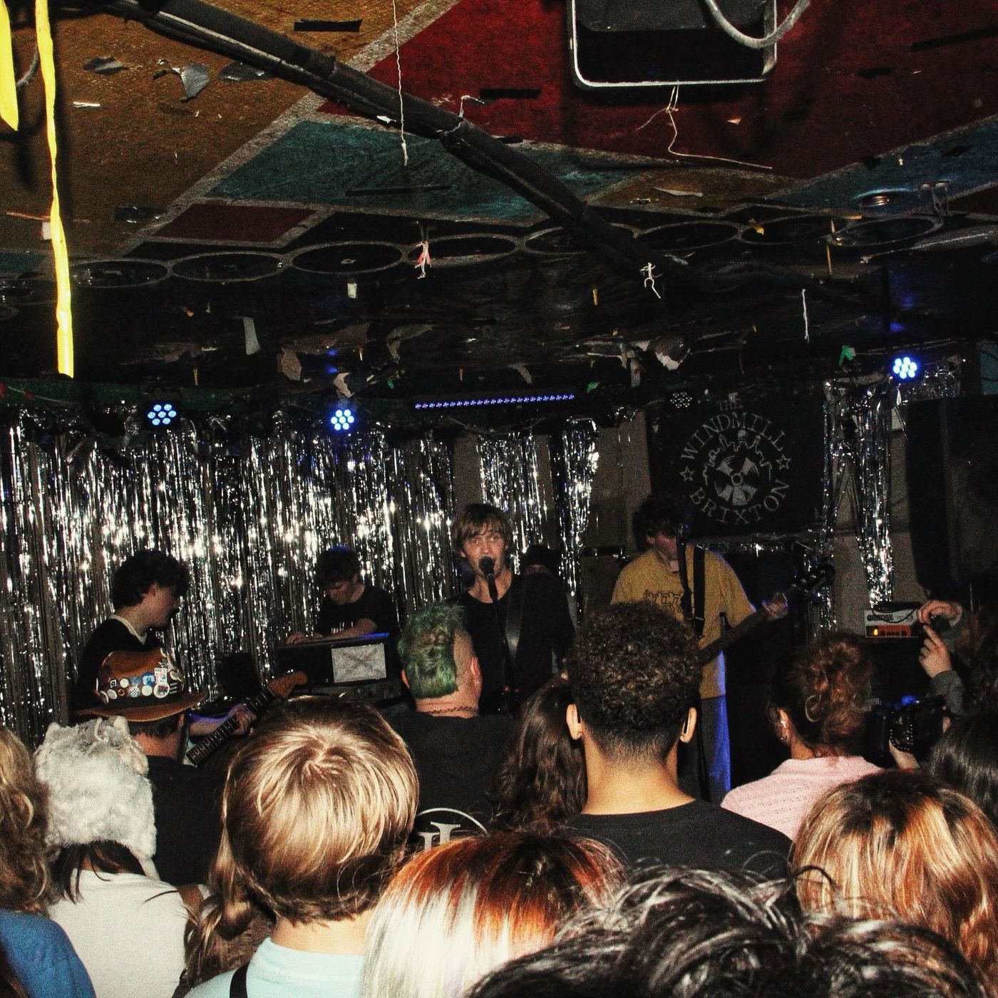 The crowd watching a band on the tinsel-draped Windmill stage