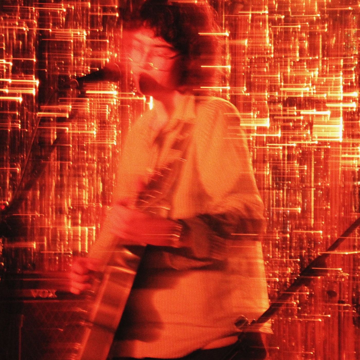 A performer blurred in red light