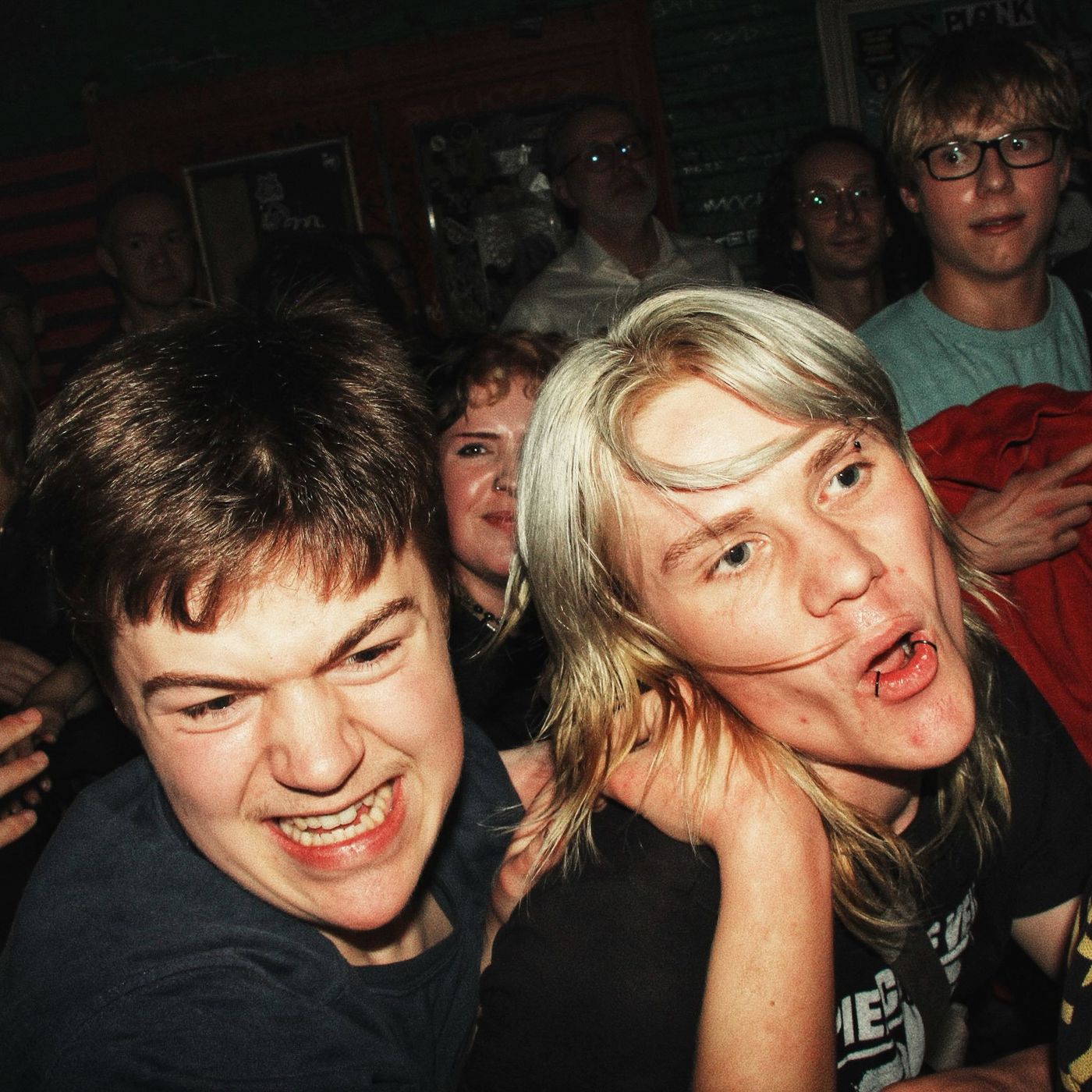 Two fans shouting along, up close
