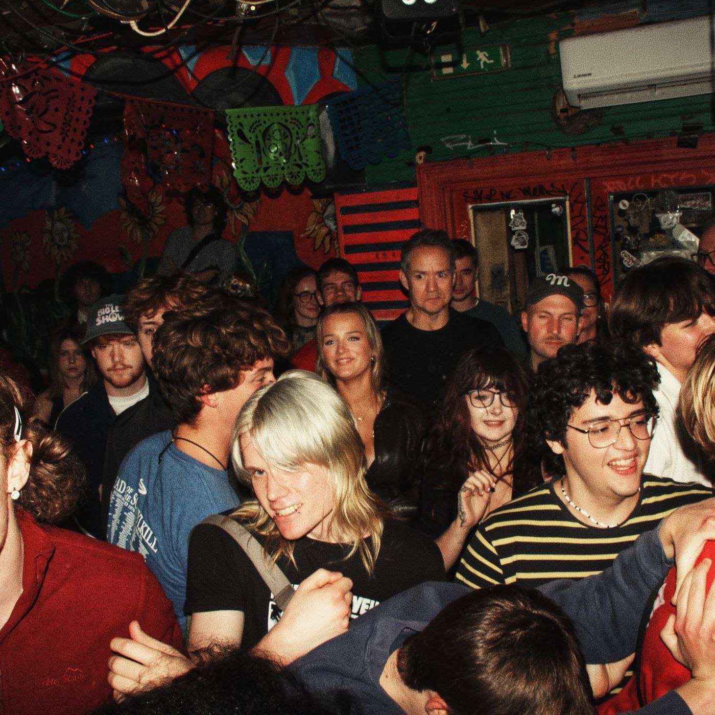 A packed room under paper bunting