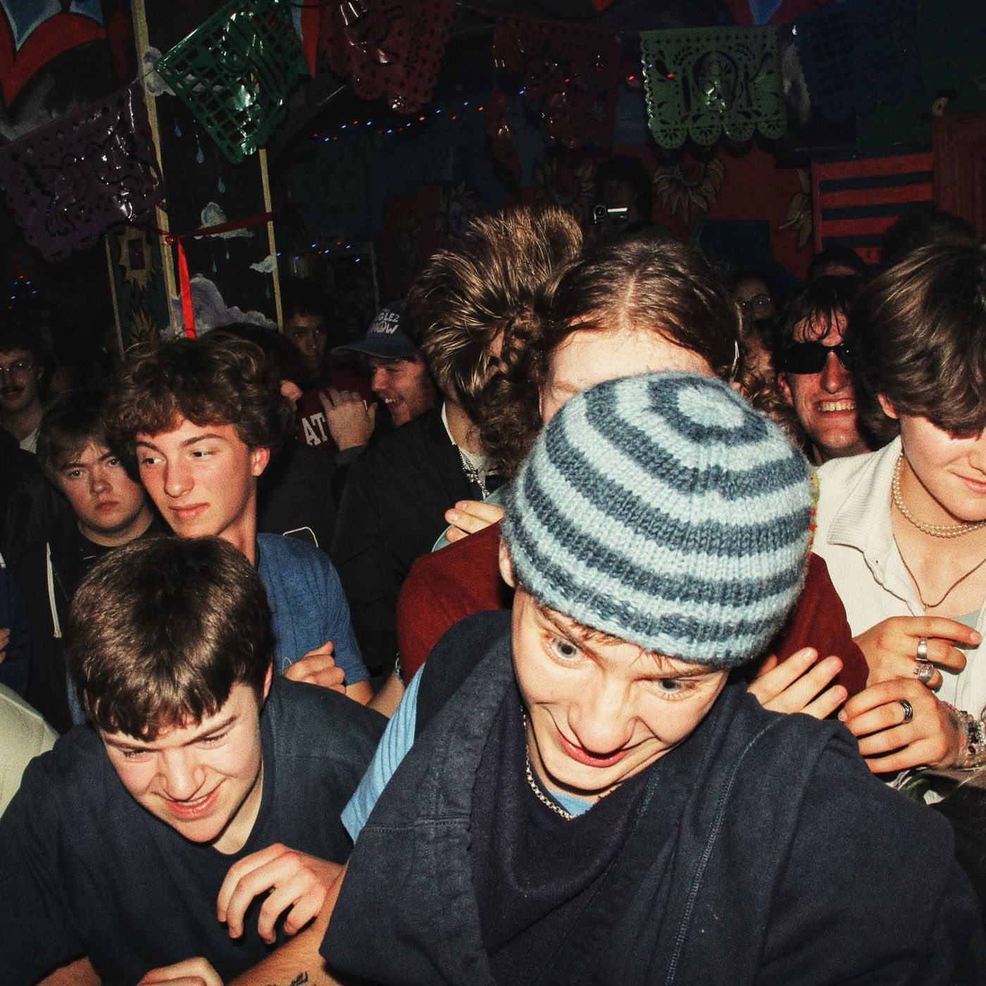 The crowd pressed together, one fan in a striped beanie