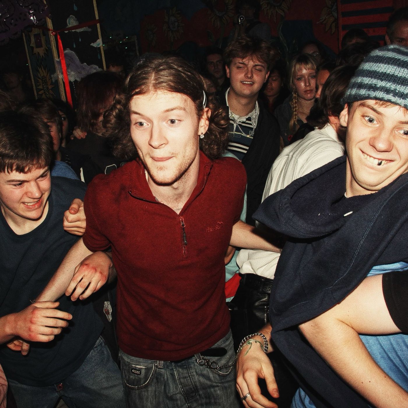 A fan in a red shirt in the middle of the pit